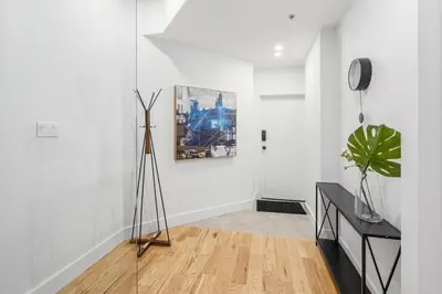 a white room with a tripod and a painting on the wall at Mont Royal Prime Residence in Montréal