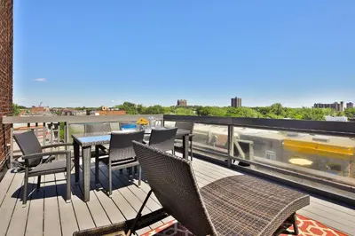 a deck with chairs and a table on a balcony at Mont Royal Prime Residence in Montréal