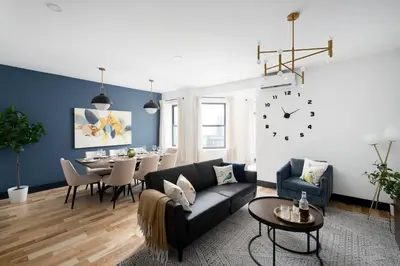 a living room with a couch and a table at Les Residences Saint Laurent- Parc Mont Royal in Montréal