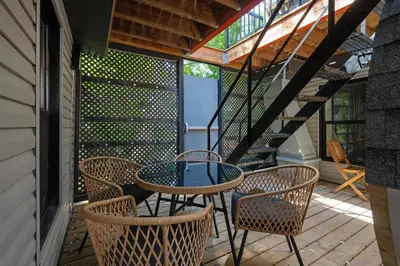 a patio with a table and chairs and a staircase at Les Residences Saint Laurent- Parc Mont Royal in Montréal