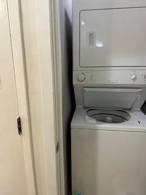 a white washer and dryer in a room at Downtown Montreal Airport 15Mins in Montréal