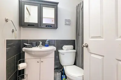a bathroom with a toilet and a sink and a mirror at Studio COZY - Rue Ste-Catherine in Montréal