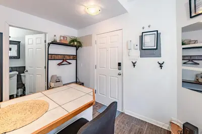 a dining room with a table and a door at Studio COZY - Rue Ste-Catherine in Montréal