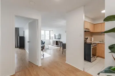 an open kitchen and living room in a apartment at LaCité Apartments Modern Comfort Close to Downtown Montreal in Montréal