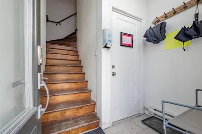 a staircase with wooden floors and an open door at Apartment ROOMY - Plateau Mont-Royal in Montréal