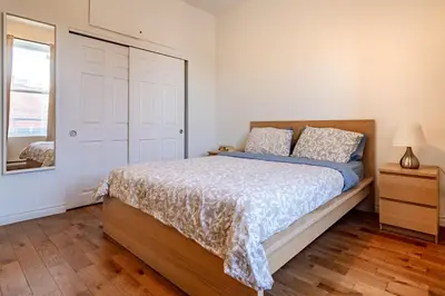 a bedroom with a bed and a window at Apartment ROOMY - Plateau Mont-Royal in Montréal