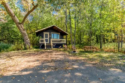 a small cabin in the middle of a forest at Chalet 3 - Domaine de l Archipel in Sorel
