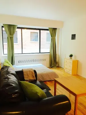 a living room with a couch and a bed at Stylish Montreal Apartment Comfortable Stay in the Golden Square Mile in Montréal