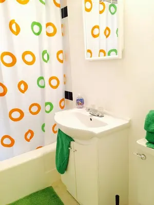 a bathroom with a sink and a shower curtain at Stylish Montreal Apartment Comfortable Stay in the Golden Square Mile in Montréal