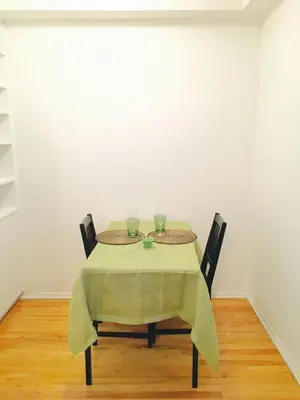 a table with two glasses on top of it at Stylish Montreal Apartment Comfortable Stay in the Golden Square Mile in Montréal
