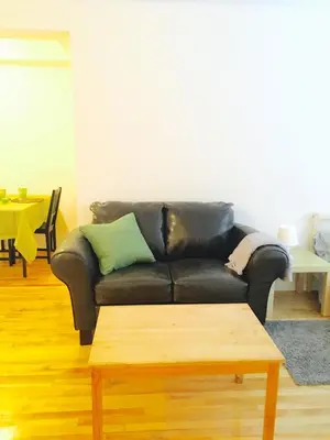 a black leather couch in a living room with a coffee table at Stylish Montreal Apartment Comfortable Stay in the Golden Square Mile in Montréal