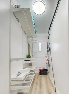 a room with white walls and a white shelf at Stylish-24 1-Bedroom in HoMa Montreal in Montréal