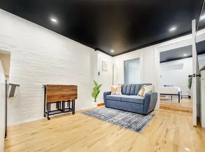 a living room with a couch and a piano at Stylish-24 1-Bedroom in HoMa Montreal in Montréal