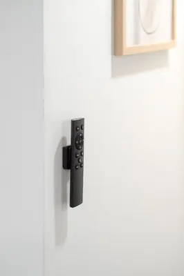 a black door handle on a white door at Stylish-24 1-Bedroom in HoMa Montreal in Montréal