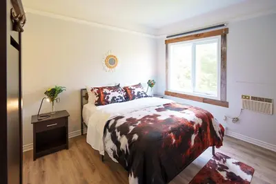 a bedroom with a bed and a window at Hotel Room in Varennes in Varennes