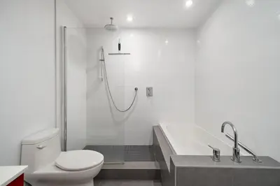 a bathroom with a shower and a toilet and a tub at 3 bedroom Penthouse Great for family vacation in Montréal