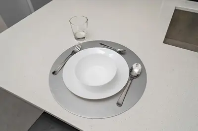 a plate and two spoons and a glass on a table at 3 bedroom Penthouse Great for family vacation in Montréal