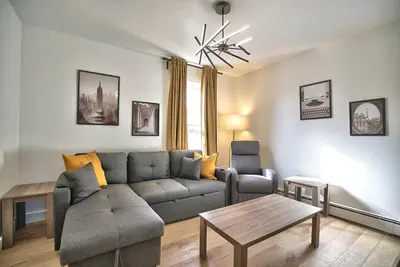 a living room with a couch and a table at Sherby LUX - Central, Parking, Renovated, Sleeps 6 in Sherbrooke