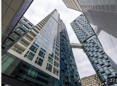 a tall building with many windows in a city at High-End Condo for Rent in Montréal