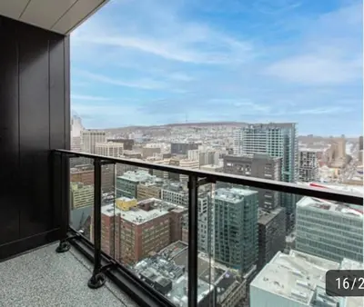 a balcony with a view of a city at High-End Condo for Rent in Montréal