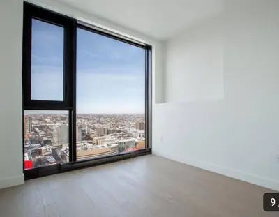 an empty room with a large window with a view at High-End Condo for Rent in Montréal