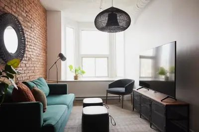 a living room with a couch and a tv at The Suzanne by Denstays in Montréal
