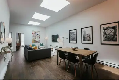 a living room with a table and a couch at Stylish and bright 2bdr near St-Hubert Plaza in Montréal