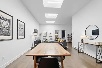 a dining room with a table and a couch at Modern and Cozy 2bdr near St-Hubert Plaza in Montréal