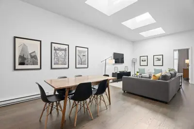 a living room with a table and chairs and a couch at Modern and Cozy 2bdr near St-Hubert Plaza in Montréal