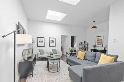 a living room with a couch and a table at Modern and Cozy 2bdr near St-Hubert Plaza in Montréal