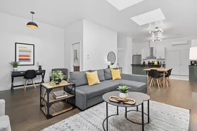 a living room with a couch and a table at Modern and Cozy 2bdr near St-Hubert Plaza in Montréal