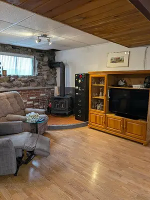 a living room with a couch and a large television at Style Chalet in Montréal