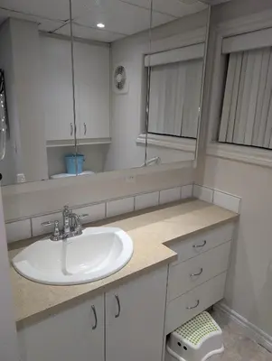 a bathroom with a sink and a mirror at Style Chalet in Montréal