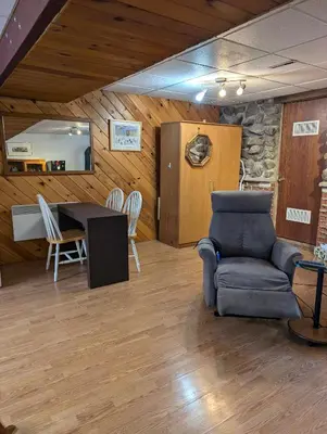 a living room with a couch and a table at Style Chalet in Montréal