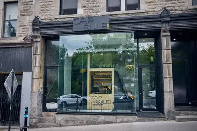 a store front with a car in the window at Capsule Hotel Montreal in Montréal