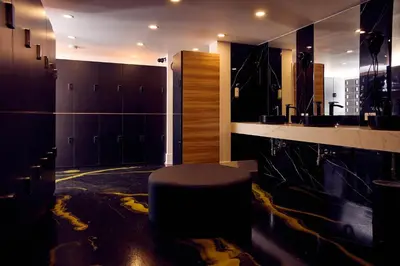 a bathroom with a stool in the middle of a room at Capsule Hotel Montreal in Montréal