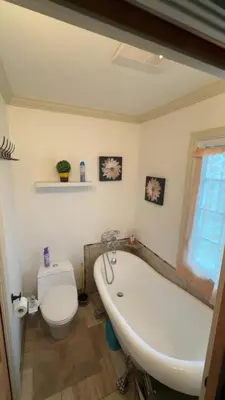 a bathroom with a white tub and a toilet at Paradise Eastern Township cottage in Cowansville