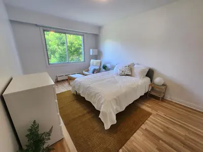 a bedroom with a bed and a window at Large & bright 3 bedroom in MTL in Montréal