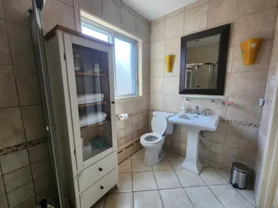 a bathroom with a toilet and a sink and a mirror at Large & bright 3 bedroom in MTL in Montréal