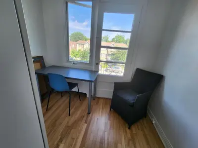 a desk and a chair in a room with a window at Large & bright 3 bedroom in MTL in Montréal