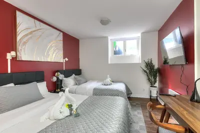 two beds in a room with red walls at Fox Aparthotel - Palais Des Congres in Montréal