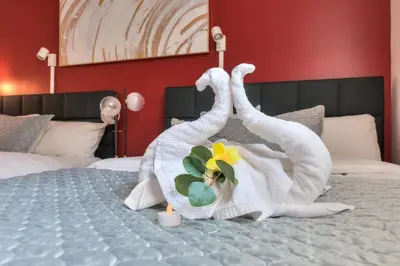 two swans made out of towels on a bed at Fox Aparthotel - Palais Des Congres in Montréal