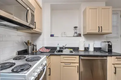 a kitchen with a stove and a sink at Fox Aparthotel - Palais Des Congres in Montréal