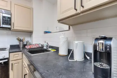 a kitchen with a counter top with a refrigerator at Fox Aparthotel - Palais Des Congres in Montréal