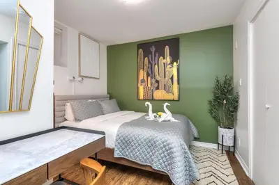 a bedroom with a bed and a green wall at Fox Aparthotel - Palais Des Congres in Montréal