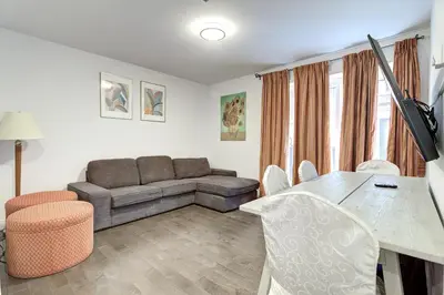 a living room with a couch and a table and chairs at Le Bijou Airhome in Montréal