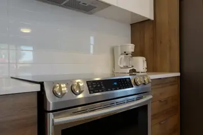 a kitchen with a stainless steel stove top oven at Le Bijou Airhome in Montréal