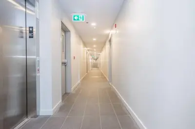 a long hallway with a sign that reads exit at Le Bijou Airhome in Montréal