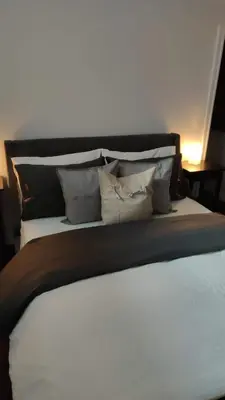 a bedroom with a large bed with pillows at Tranquille Discret Privé in Laval