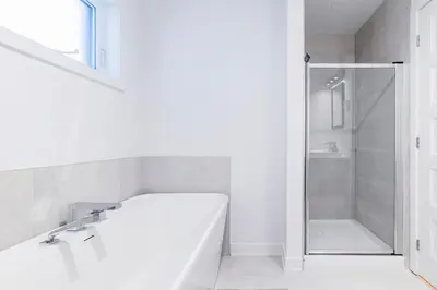 a white bathroom with a tub and a shower at Longueuil New Stylish 3-BDR free parking close to Dix 30&DT in Longueuil